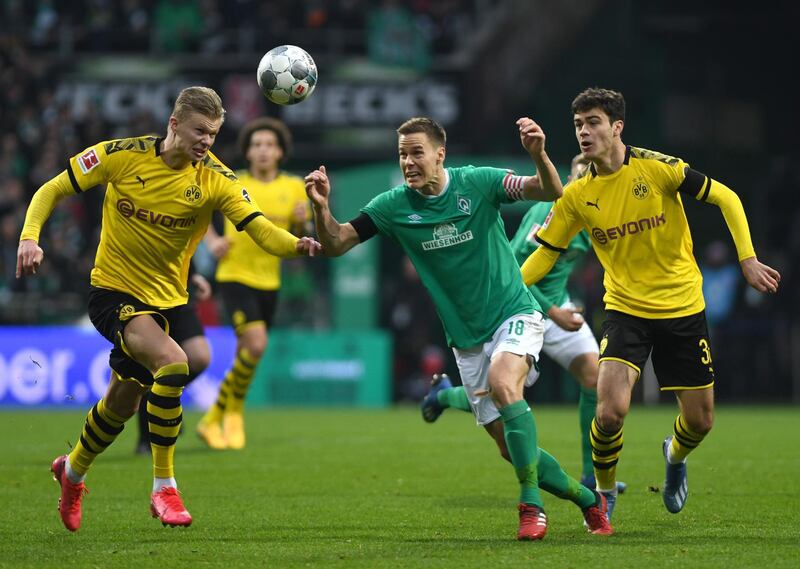 Erling Haaland, left, contests a ball with Bremen's Niklas Moisander. EPA