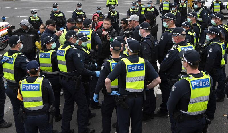 Police confront anti-vaccination and lockdown protesters in Melbourne, as the city enters the second day of a seven-day lockdown after a spike in community transmission of the Covid-19 coronavirus.  AFP