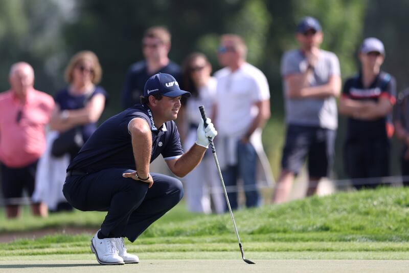 Patrick Reed lines-up a putt on the 14th green. Getty