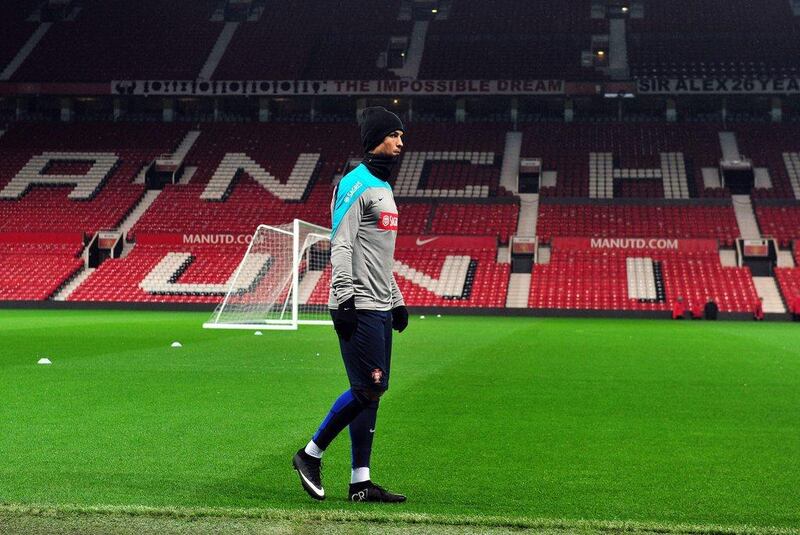 Portugal's Cristiano Ronaldo walks around the pitch during Monday night's team training session at Manchester United's Old Trafford grounds, where he used to play. Paul Ellis / AFP