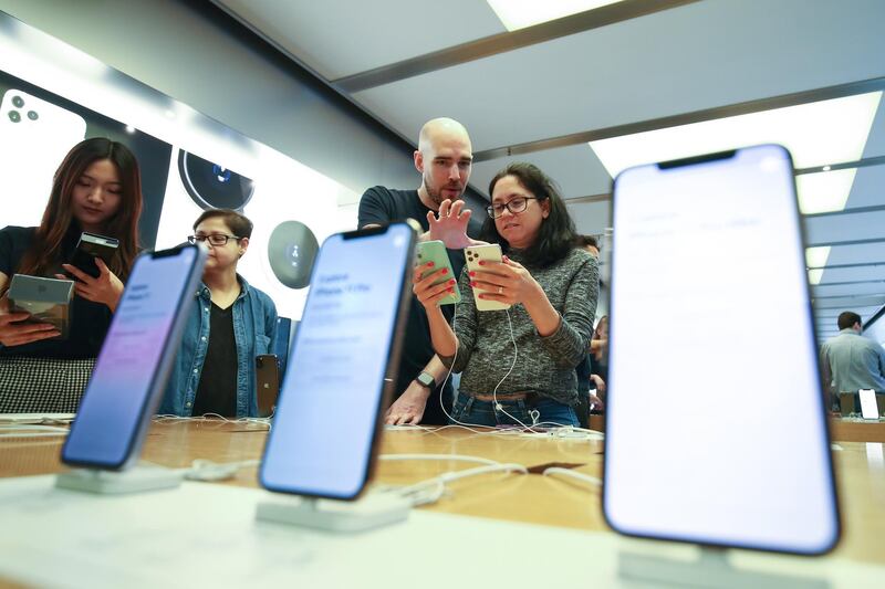 Attendees look at Apple Inc. iPhone 11 smartphones displayed at an Apple store in Sydney. Bloomberg