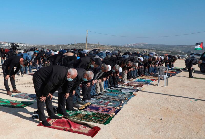 Palestinian protesters perform Friday prayers ahead of a protest against Israeli settlements in the occupied West Bank on December 4, 2020. AFP
