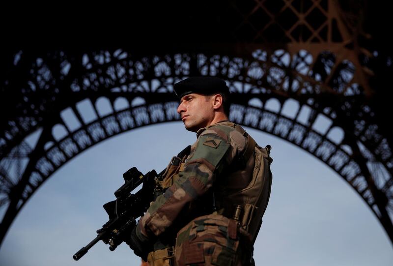 FILE PHOTO: A French soldier stands guard under the Eiffel Tower, as France officially ended a state of emergency regime, replacing it with the introduction of a new security law, in Paris, France, November 1, 2017. REUTERS/Christian Hartmann - File Photo