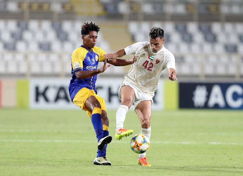 Abu Dhabi, United Arab Emirates - August 12, 2019: Leonardo of Al Wahda and Abdulrahman Aldosari of Al Nassr battle during the Asian Champions League round 16 return leg between Al Wahda of the UAE and Al Nassr of Saudi Arabia. Monday the 12th of August 2019. Al Wadha, Abu Dhabi. Chris Whiteoak / The National