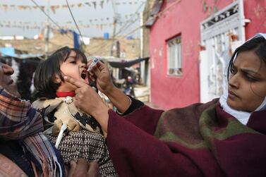 A Pakistani health worker administers polio vaccine drops to a child during a polio vaccination campaign in Islamabad on December 12, 2018. AFP