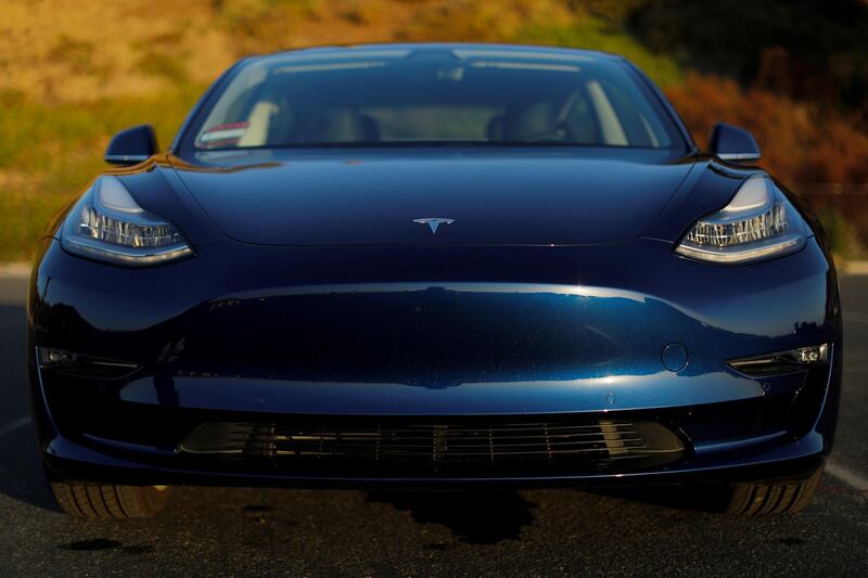 A 2018 Tesla Model 3 electric vehicle is shown in this photo illustration taken in Cardiff, California, U.S., June 1, 2018. Picture taken June 1, 2018.   REUTERS/Mike Blake