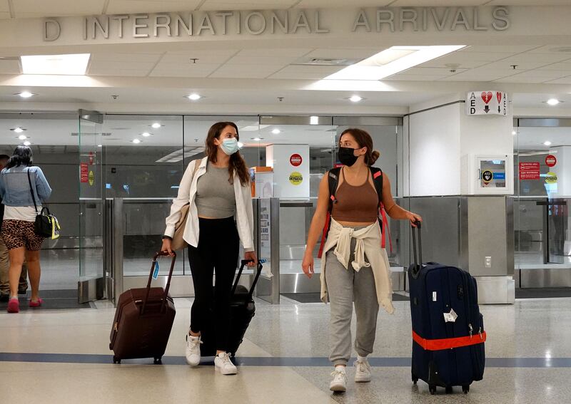 Travellers arrive at Miami International Airport. The US is set to ease restrictions on fully vaccinated foreign visitors from November. AFP