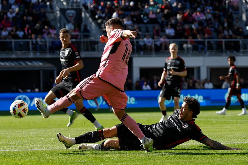 DC United defender Aaron Herrera attempts a slide tackle on Inter Miami full-back Jordi Alba. USA Today