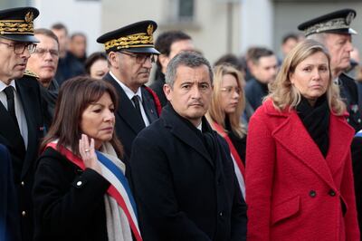 French Interior Minister Gerald Darmanin, centre, and Paris Mayor Anne Hidalgo, left, attend a ceremony marking the eighth anniversary of the attack on the offices of Charlie Hebdo in the French capital. AFP