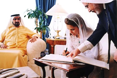 Jordan's Princess Haya, King Abdullah II's half-sister, right, signs her wedding register to Dubai's Crown Prince and Defence Minister Mohammed bin Rashed al-Maktoum, who is seen sitting at left, at the Baraka Palace in Amman, Jordan, Saturday April 10, 2004. Princess Haya, 29, is the eldest daughter of Jordan's late King Hussein from his third wife, Alia-Touqan, a Palestinian Jordanian who died in a 1977 helicopter crash. Prince Sheik Mohammed and Princess Haya, were married Saturday.(AP Photo/Royal Palace)