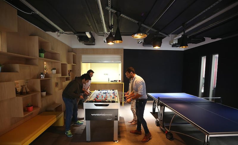 Employees play games at the Google office  in Dubai. Satish Kumar / The National