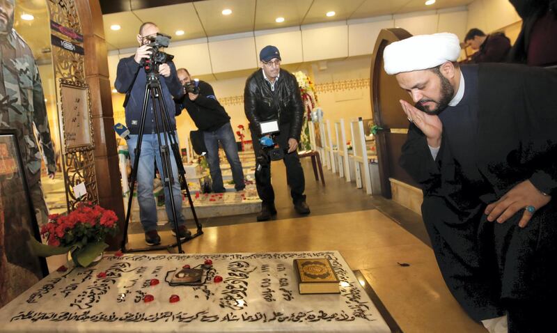 Secretary General of Shitte Iraqi Al-Nujabaa movement Akram al-Kaabi prays over the tomb of Hezbollah slain military leader Imad Moghnieh in Beirut's southern suburb on February 13, 2018. (Photo by ANWAR AMRO / AFP) / “The erroneous mention[s] appearing in the metadata of this photo by ANWAR AMRO has been modified in AFP systems in the following manner: [Akram] instead of [Abbas]. Please immediately remove the erroneous mention[s] from all your online services and delete it (them) from your servers. If you have been authorized by AFP to distribute it (them) to third parties, please ensure that the same actions are carried out by them. Failure to promptly comply with these instructions will entail liability on your part for any continued or post notification usage. Therefore we thank you very much for all your attention and prompt action. We are sorry for the inconvenience this notification may cause and remain at your disposal for any further information you may require.”