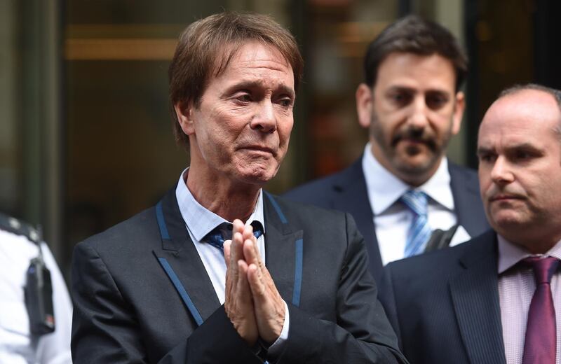 epa06896058 An emotional Sir Cliff Richard (C) makes a short statement to the press outside the High Court in London, Britain, 18 July 2018. Sir Richard has been awarded 210,000 British Pounds damages in his privacy battle against the British Broadcasting Company (BBC) over their coverage of a police raid of his home. Others are not identified.  EPA/ANDY RAIN