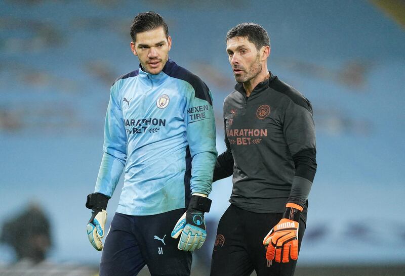 MANCHESTER, ENGLAND - JANUARY 13: Ederson of Manchester City and Xabi Mancisidor, goalkeeping coach of Manchester City look on during the warm up prior to the Premier League match between Manchester City and Brighton & Hove Albion at Etihad Stadium on January 13, 2021 in Manchester, England. Sporting stadiums around England remain under strict restrictions due to the Coronavirus Pandemic as Government social distancing laws prohibit fans inside venues resulting in games being played behind closed doors. (Photo by Matt McNulty - Manchester City/Manchester City FC via Getty Images)