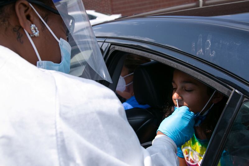 Nurse Celeste Moore, tests 11.5 years old Samira Javed for coronavirus at Seneca High School a day before returning to school in Louisville, Kentucky, US, on August 10, 2021. Reuters