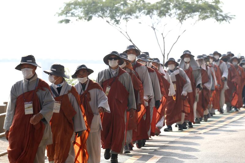 South Korean buddhist monks walk along a road in Seoul, South Korea. About 90 monks their followers started 500-kilometer pilgrimage from Donghwa Temple in the southeastern city of Daegu to wish for the country to overcome the coronavirus pandemic. Getty Images
