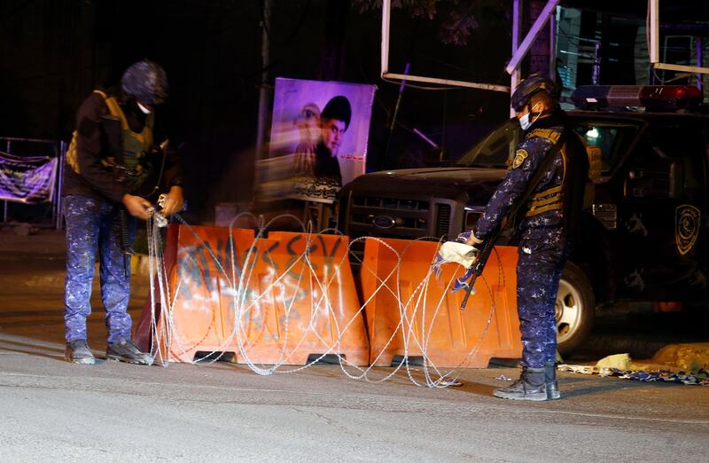 Security forces close off streets in Baghdad at the start of the new curfew to prevent the spread of Covid-19 in Iraq.  AP Photo