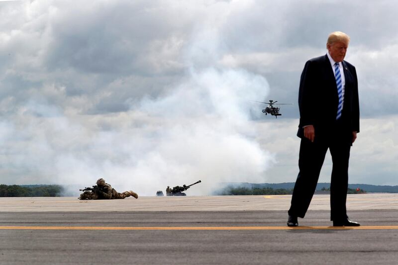 FILE PHOTO: U.S. President Donald Trump observes a demonstration with U.S. Army 10th Mountain Division troops, an attack helicopter and artillery as he visits Fort Drum, New York, U.S., August 13, 2018. REUTERS/Carlos Barria/File Photo