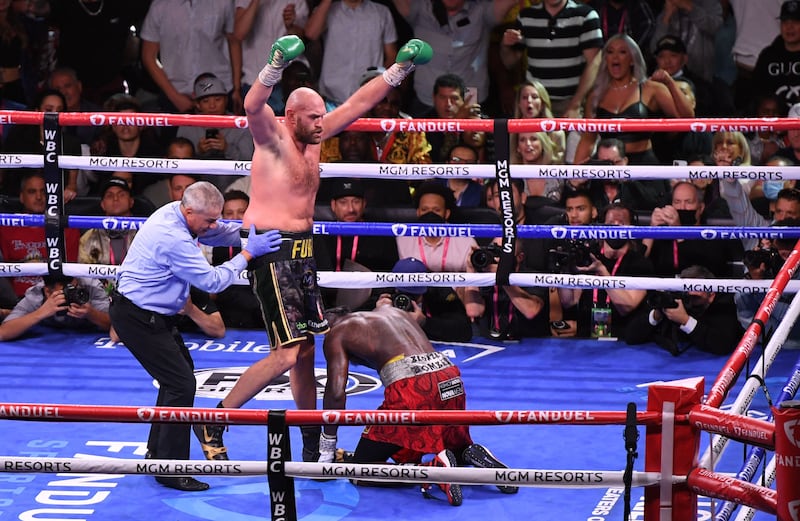 Tyson Fury raises his arms after knocking down Wilder in the tenth round - but that wasn't the end. Reuters