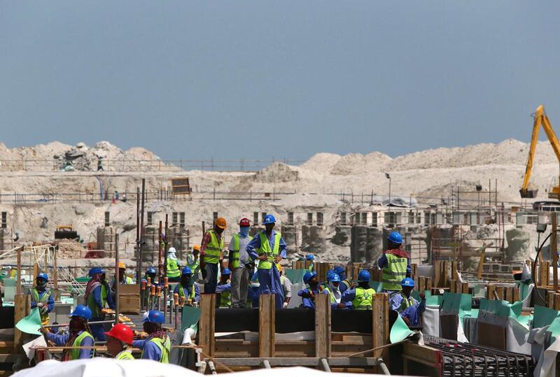 Workers at the site where the Lovure Abu Dhabi is being constructed. Marwan Naamani / AFP