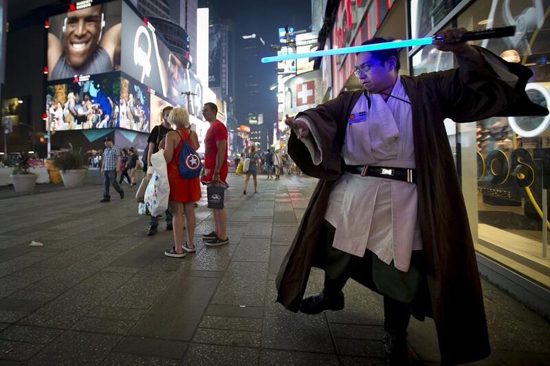Star Wars fan Mike Deguzman practices with a toy lightsaber after purchasing some new toys in New York. Carlo Allegri / Reuters