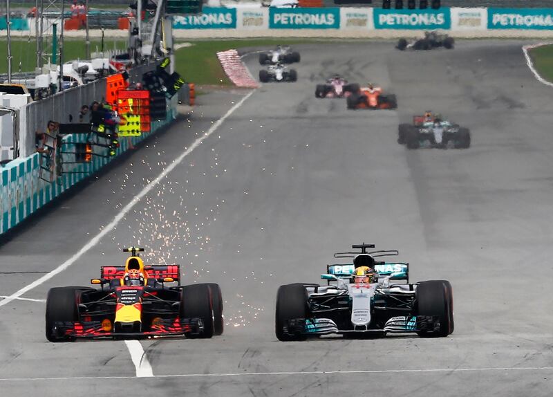 Formula One F1 - Malaysia Grand Prix 2017 - Sepang, Malaysia - October 1, 2017.  Redbull���s Max Verstappen attemps to overtake Mercedes��� Lewis Hamilton during the race. REUTERS/Lai Seng Sin
