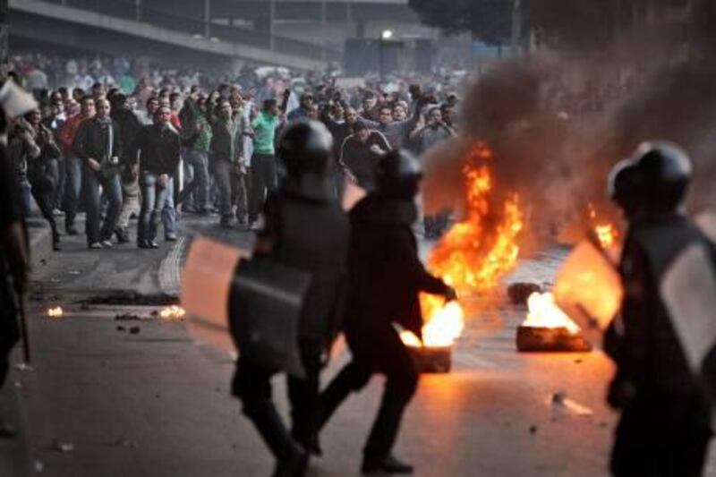 Egyptian riot police clash with anti-government activists in Cairo, Egypt, Wednesday, Jan. 26, 2011.  Egyptian anti-government activists clashed with police for a second day Wednesday in defiance of an official ban on any protests but beefed up police forces on the streets quickly moved in and used tear gas and beatings to disperse demonstrations. (AP Photo/Ben Curtis) *** Local Caption ***  ABC118_APTOPIX_Mideast_Egypt_Protest.jpg