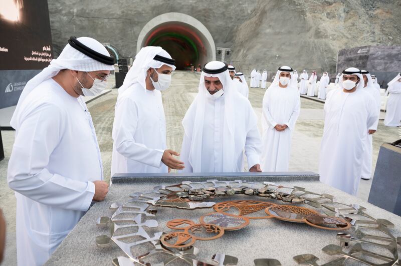 Sheikh Hamad bin Mohammed Al Sharqi, the Ruler of Fujairah, accepts a gift from Sheikh Theyab bin Mohamed bin Zayed, chairman of the Department of Transport and Abu Dhabi Executive Council Member, during a ceremony to celebrate the completion of tunnel excavations for the national rail network. Also present are Sheikh Mohammed bin Hamad Al Sharqi, Crown Prince of Fujairah, Sheikh Maktoum bin Hamad Al Sharqi and Shadi Malik, chief executive of Etihad Rail, left.