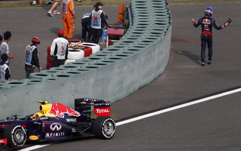 Mark Webber shows his frustration as he walks away from his stricken Red Bull in Shanghai. Pic: Aly Song/Reuters