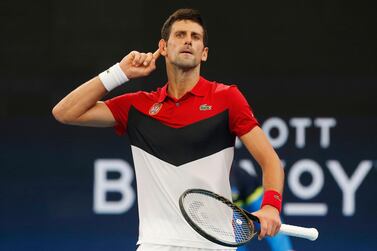 Novak Djokovic of Serbia gestures to the crowd during their ATP Cup tennis match against Denis Shapovalov of Canada in Sydney, Friday, Jan. 10, 2020. (AP Photo/Steve Christo)