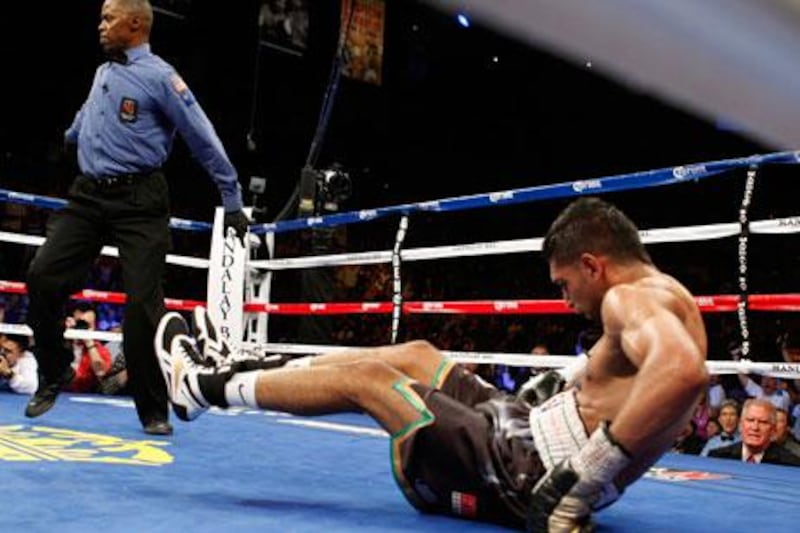 Amir Khan is dumped to the canvas by a blow from Danny Garcia (not pictured) during their unification bout in Las Vegas