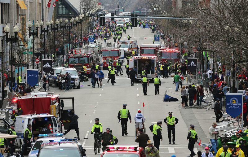 Medical workers respond following an explosion at the 2013 Boston Marathon in Boston, Monday, April 15, 2013. Two explosions shattered the euphoria of the Boston Marathon finish line on Monday, sending authorities out on the course to carry off the injured while the stragglers were rerouted away from the smoking site of the blasts. (AP Photo/The Boston Globe, David L Ryan)   *** Local Caption ***  Boston Marathon Explosions.JPEG-00546.jpg