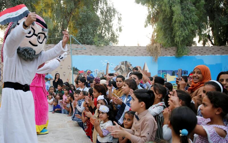 A man wearing a costume dances during a kids show at Nineveh 3rd World Peace Festival in Mosul, Iraq. Reuters