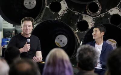 SpaceX founder and chief executive Elon Musk, left, announces Japanese billionaire Yusaku Maezawa, right, as the first private passenger on a trip around the moon, Monday, Sept. 17, 2018, in Hawthorne, Calif. (AP Photo/Chris Carlson)