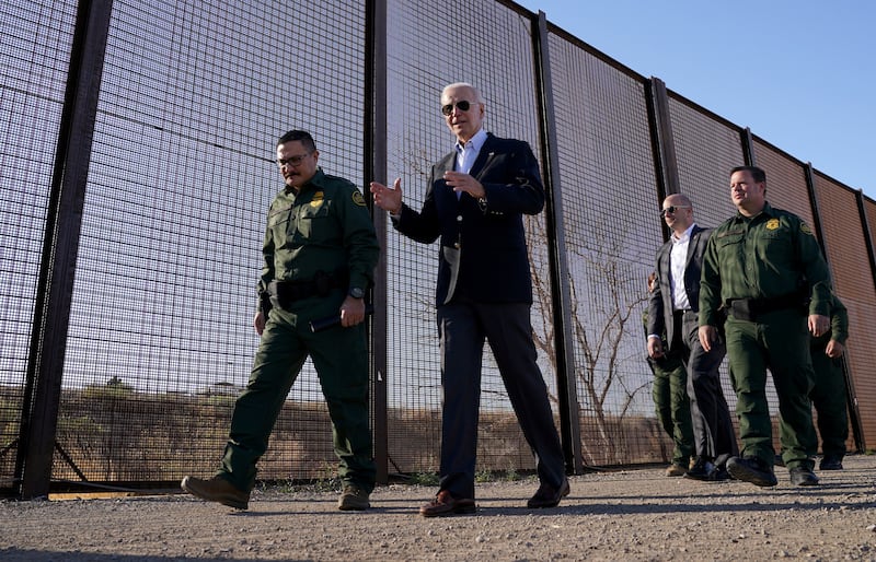 Mr Biden walks along the border fence during his visit to the US-Mexico border. Reuters