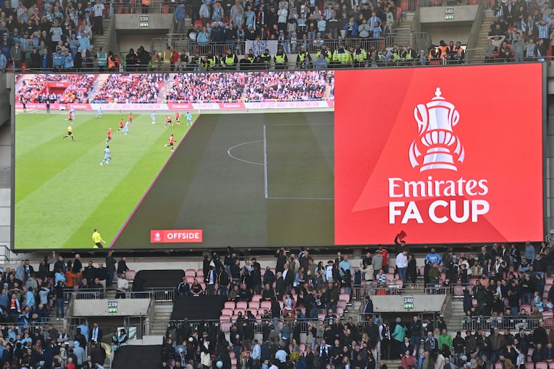 A big screen at Wembley shows the offside call by VAR in the build-up to a goal from Coventry's Victor Torp. AFP
