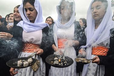 Iraqi Yazidis take part in a ceremony during the exhumation of a mass-grave of hundreds of Yazidis killed by ISIS in the northern Iraqi village of Kojo in Sinjar. AFP