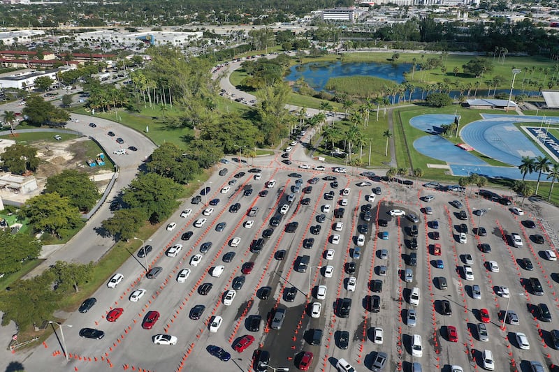 Cars line up at a drive-through Covid-19 testing site at Tropical Park in Miami, Florida. As Covid-19 cases rise in the US, healthcare workers are urging people to take precautions during holiday get-togethers. AFP
