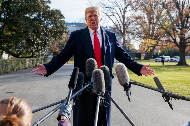 FILE - In this Dec. 7, 2018, file photo, President Donald Trump announces that he is nominating William Barr as his Attorney General, on the South Lawn of the White House, in Washington. Barr, once questioned the effectiveness of a border wall similar to the one the president now wants to construct. Barr was attorney general under President George H.W. Bush when he was asked in a 1992 interview if he supported a proposal from Republican challenger Pat Buchanan to erect a barrier of ditches and fences along the Mexican border to stem the flow of illegal immigrants. Barr described a side-to-side barrier as â€œoverkill.â€ (AP Photo/Evan Vucci, File)