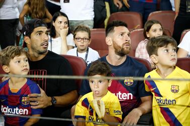 Barcelona's Lionel Messi, right, and Barcelona's Luis Suarez sit in the stands prior of the Spanish La Liga soccer match between FC Barcelona and Betis at the Camp Nou stadium in Barcelona, Spain, Sunday, Aug. 25, 2019. (AP Photo/Joan Monfort)