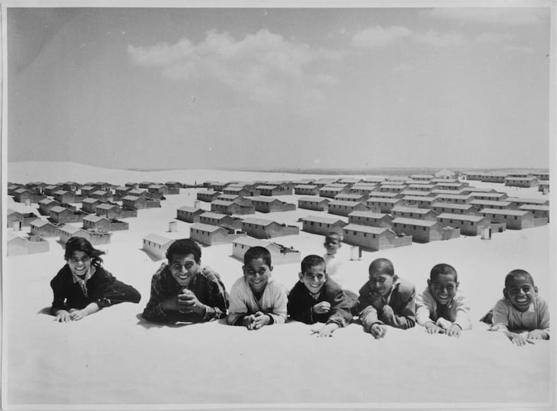In this 1971 photo from the UNRWA archive, Palestinian refugees pose for a picture in the New Amman refugee camp in Eastern Jordan. AP Photo/G.Nehmeh, UNRWA Photo Archives
