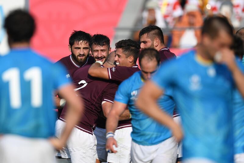 Georgia's hooker Jaba Bregvadze celebrates with teammates after scoring a try against Uruguay. AFP