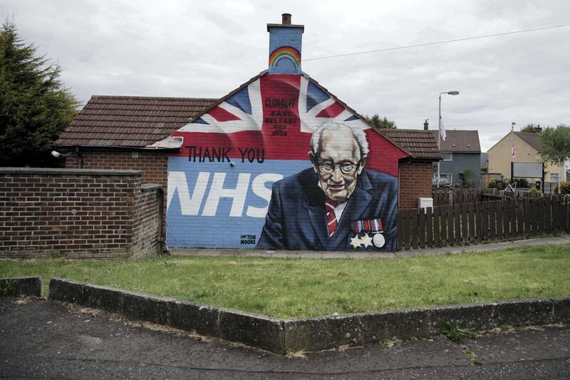 BELFAST, NORTHERN IRELAND - MAY 18: A mural depicting 100 year old army veteran and NHS fund raiser Captain Tom Moore can be seen in a loyalist housing estate on May 18, 2020 in Belfast, Northern Ireland. Murals in the province traditionally express support for either loyalist or republican causes. Now during the Covid-19 pandemic new murals on both sides of the community divide have been painted in support of the NHS and in some cases have replaced or sit alongside the traditional murals. (Photo by Charles McQuillan/Getty Images)