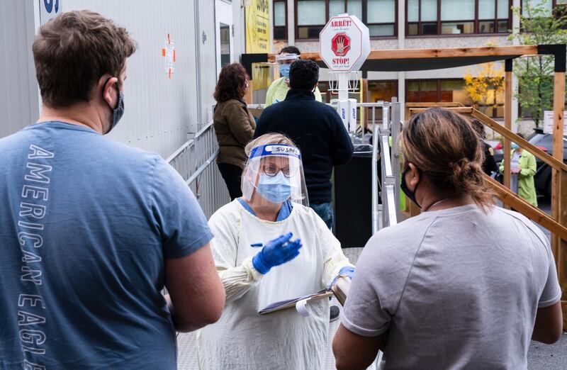 A nurse greets people at a Covid-19 walk-in clinic in Montreal. The Canadian Press via AP