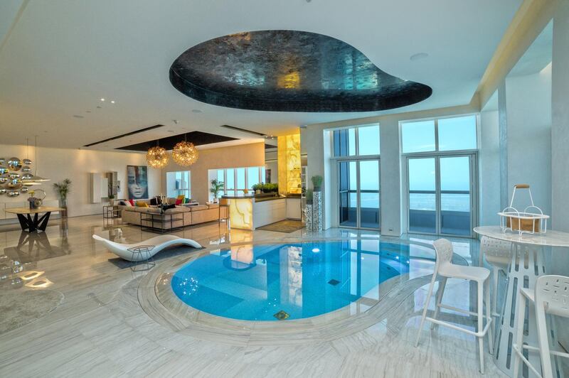 The Dubai Marina apartment's living room is open-plan, with the swimming pool included. Courtesy Allsopp and Allsopp