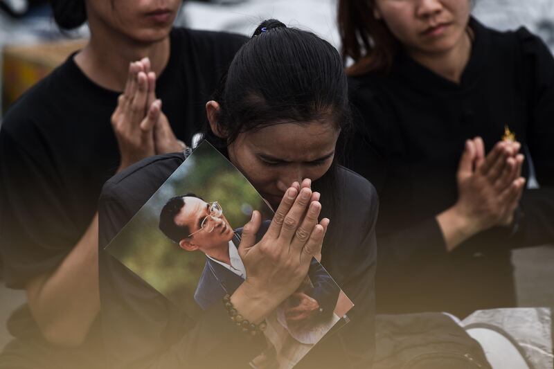 Mourners attend the funeral procession for the late Thai king Bhumibol Adulyadej in Bangkok. Lillian Suwanrumpha / AFP.