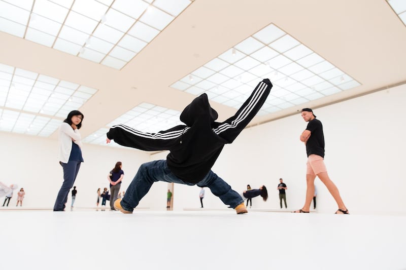 Visitors at the Museum of Contemporary Art (MOCA) in Los Angeles observe the performers of Xu Zhen's piece In Just a Blink of an Eye, on view until September 1. Myles Pettengill