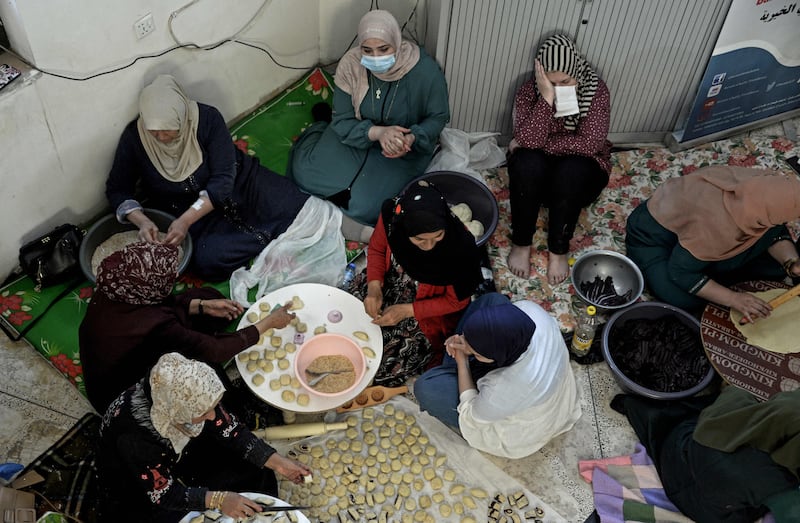 Iraqi women prepare traditional cookies in Mosul ahead of Eid Al Fitr.  AFP