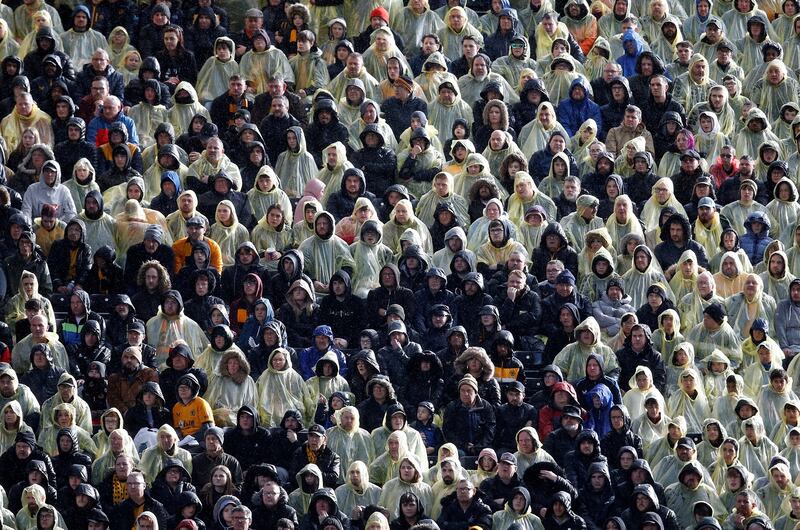 Fans of English West Midlands football team Wolverhampton Wanderers in raincoats as they watch their team's 2-4 Premier League defeat at home to Leeds United at Molineux Stadium on Saturday. Reuters 