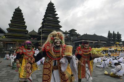 Artists perform Sidakarya mask dancing during mass prayers, expressing gratitude for the handling of the new coronavirus and seeking blessings for the start of a "new normal", at Besakih temple in Karangasem, Bali, Indonesia, July 5, 2020 in this photo taken by Antara Foto.  Antara Foto/Nyoman Hendra Wibowo/ via REUTERS ATTENTION EDITORS - THIS IMAGE WAS PROVIDED BY A THIRD PARTY. MANDATORY CREDIT. INDONESIA OUT.